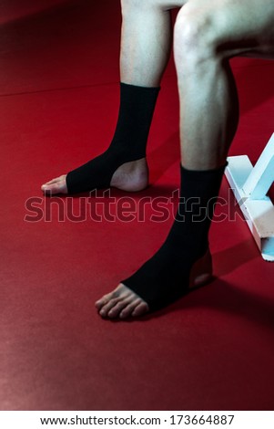 Fighter Putting Straps On His Foot
