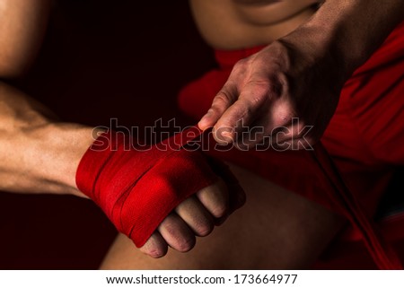 Ultimate Fighter Getting Ready - Muscled Boxer Wearing Red Strap On Wrist