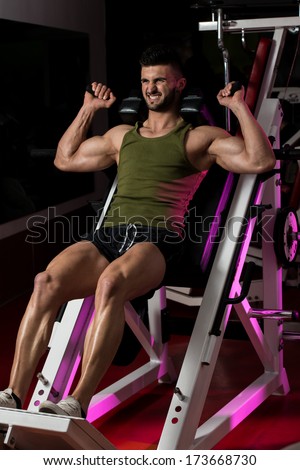Workout Leg Press - Fit Man Using The Leg Press Machine At A Health Club