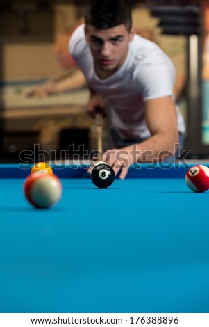 Man Playing Pool - Lining To Hit Ball On Pool Table