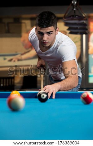 Male Pool Player - Lining To Hit Ball On Pool Table