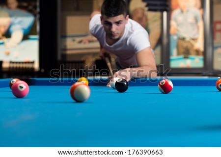 The Billiard Player - Young Man Lining To Hit Ball On Pool Table