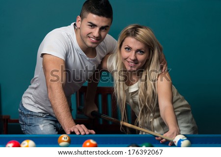Beautiful Couple Playing Pool - Young Caucasian Woman Receiving Advice On Shooting Pool Ball While Playing Billiards
