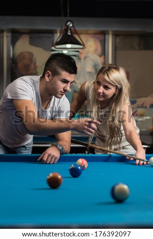 Man Teaching Woman How To Play Pool - Young Caucasian Woman Receiving Advice On Shooting Pool Ball While Playing Billiards