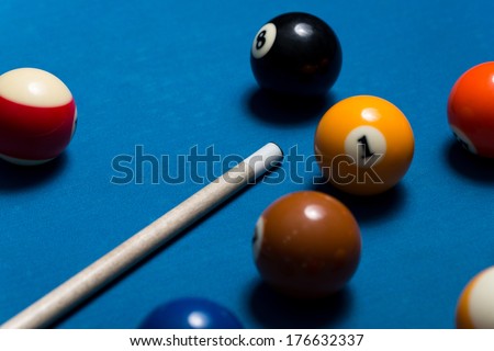 Pool Table With Balls And Cue Stick - Close-Up Of Pool Balls On A Blue Pool Table