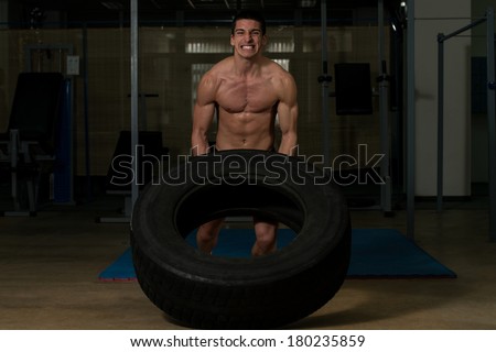 Workout By Doing A Tire Flip - Muscular Men With Truck Tire Turning Tire Over