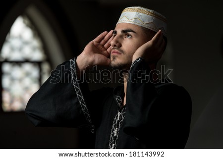 Muslim Praying In Mosque - Man Making Traditional Prayer To God While Wearing A Traditional Cap Dishdasha