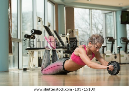 Working Out With Ab Roller - Young Woman Exercising Fitness Workout For Abdominal