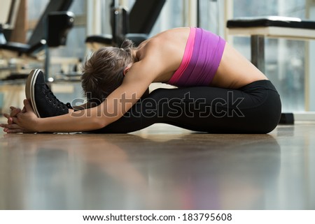 Fitness Stretch - Young Woman Stretching On The Floor
