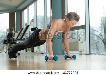Push-Ups Upper Position - Beautiful Fit Woman Doing Push ups In Healthy Club
