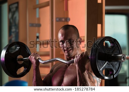 Muscular Man Doing Heavy Weight Exercise For Biceps