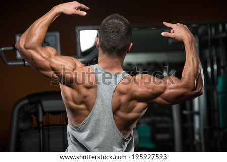 Portrait Of A Physically Fit Young Man - Flexing Muscles - No Pain No Gain