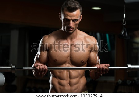 Muscular Man Doing Heavy Weight Exercise For Biceps