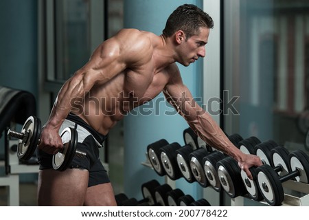 Young Athlete Exercise Triceps - He Is Performing In A Health Club