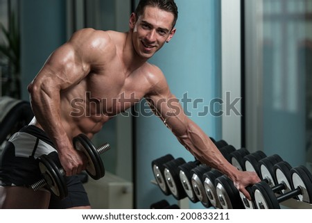 Young Athlete Exercise Triceps - He Is Performing In A Health Club