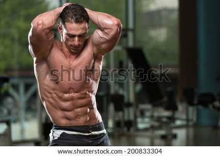 Abdominal Muscle Close-Up - Serious Men Standing In The Gym And Flexing Muscles
