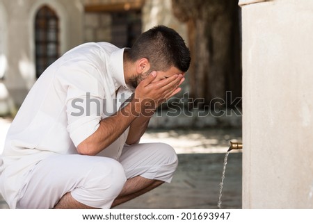 Muslim Man Preparing To Take Ablution In Mosque