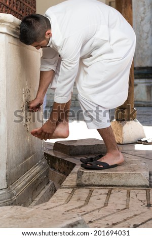 Muslim Washing Feet Before Entering Mosque