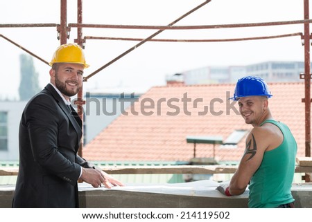 Portrait Of Builder And Businessman Working At Construction