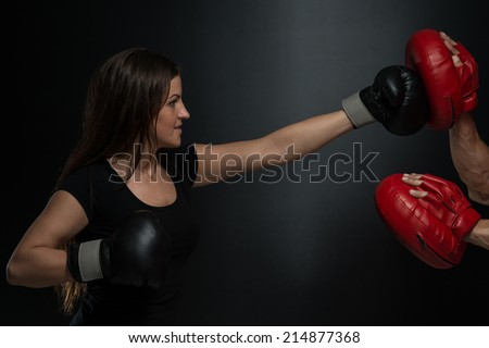 Young Fit Woman Fighting A Man - Bodybuilding Couple Posing With Boxing Gloves On Black Background