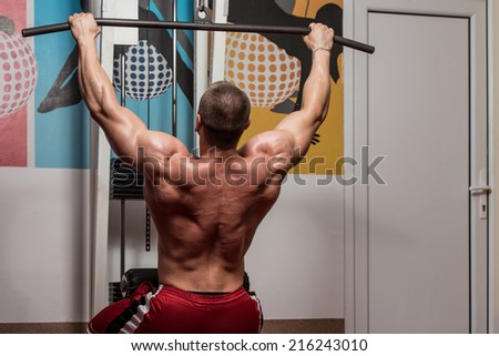Male Bodybuilder Doing Heavy Weight Exercise For Back