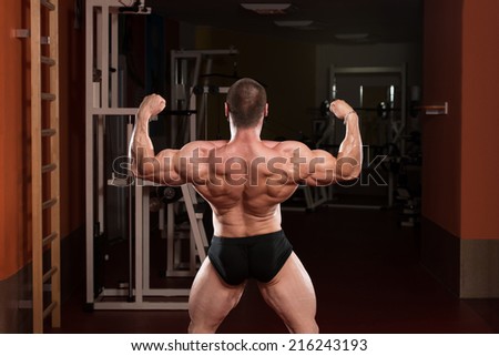Bodybuilder Performing Rear Double Biceps Poses