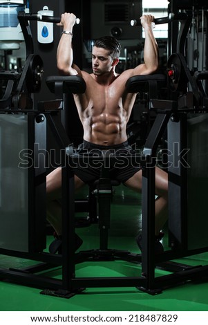 Male Bodybuilder Doing Heavy Weight Exercise For Biceps