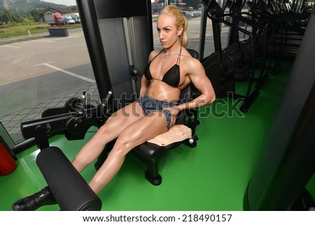 Young Woman Doing Heavy Weight Exercise For Legs