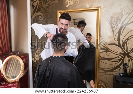 Reflection Of Hair Stylist Doing Hair Style - Handsome Young Hairdresser Giving A New Haircut To Male Customer At Parlor