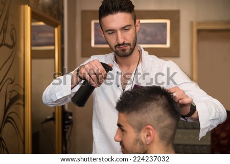 Male Hairstylist Water Sprayer On Hair On Hair - Handsome Young Hairdresser Giving A New Haircut To Male Customer At Parlor