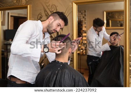 Hairdresser Making Haircut To Young Man - Handsome Young Hairdresser Giving A New Haircut To Male Customer At Parlor
