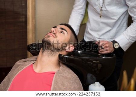 Hairdresser Washing Man Head In Barber Shop - Hairstylist Hairdresser Washing Customer Hair - Young Man Relaxing In Hairdressing Beauty Salon