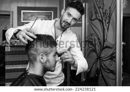 Hairdresser Cleaning Young Man After Haircut - Handsome Young Hairdresser Giving A New Haircut To Male Customer At Parlor