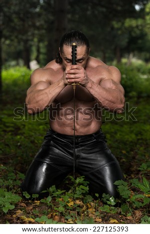 Warrior Is Praying For No Sword Fight - Standing In Forest Wearing Leather Pants