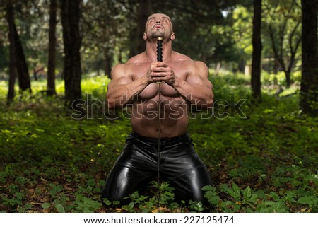 Strong Man With Samurai Sword - Standing In Forest Wearing Leather Pants