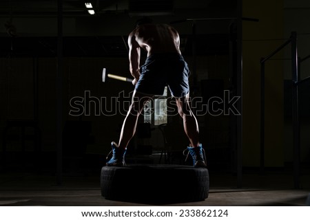 Athletic Man Hits Tire - Workout At Gym With Hammer And Tractor Tire Siluet