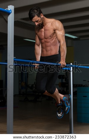 Fit Athlete Working Out Exercise On Parallel Bars