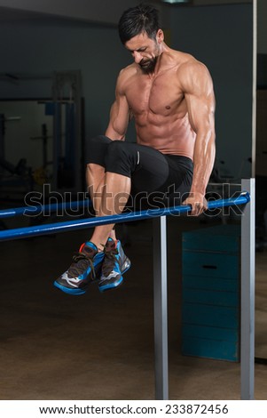 Fit Athlete Working Out Exercise On Parallel Bars