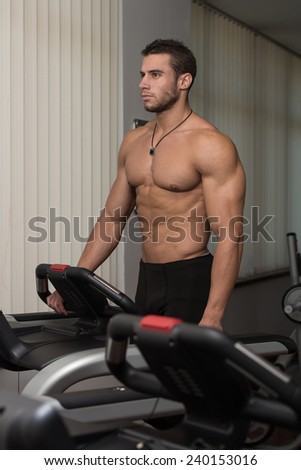 Man Running On Treadmill At A Health Club