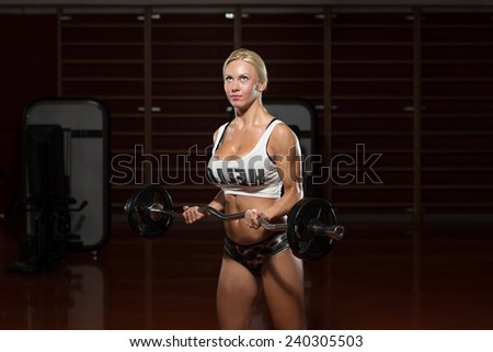 Young Woman Athlete Doing Heavy Weight Exercise For Biceps