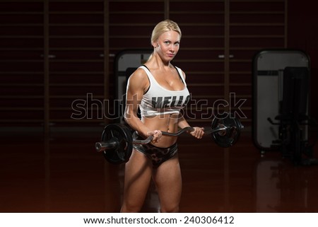 Young Woman Athlete Doing Heavy Weight Exercise For Biceps