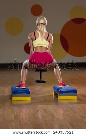 Young Woman Performing Dumbbell Barbell Squats - One Of The Best Body Building Exercise For Legs