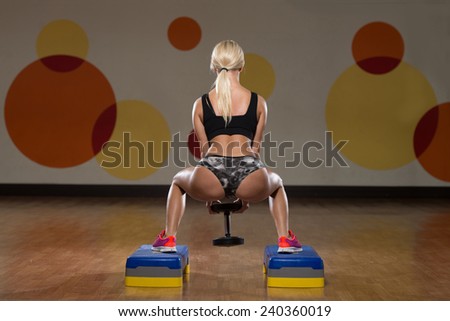 Young Woman Performing Dumbbell Squats - One Of The Best Body Building Exercise For Legs