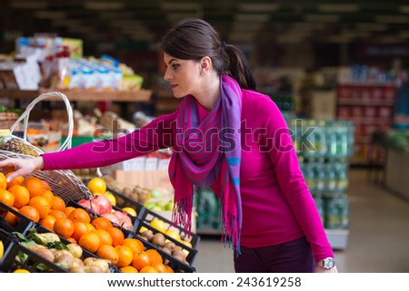 Beautiful Young Woman Shopping For Fruits And Vegetables In Produce Department Of A Grocery Store - Supermarket - Shallow Deep Of Field