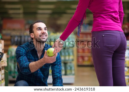 Beautiful Young Couple Shopping For Fruits And Vegetables In Produce Department Of A Grocery Store - Supermarket - Shallow Deep Of Field