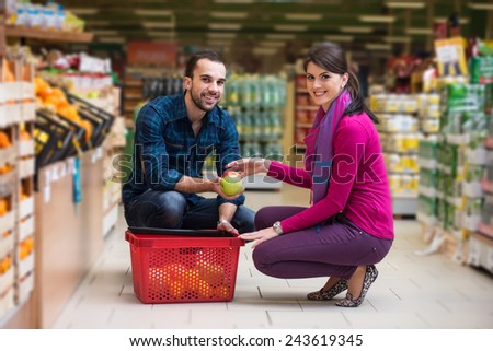 Beautiful Young Couple Shopping For Fruits And Vegetables In Produce Department Of A Grocery Store - Supermarket - Shallow Deep Of Field