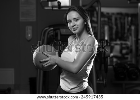 Young Woman Exercise With Medical Ball In Fitness Club