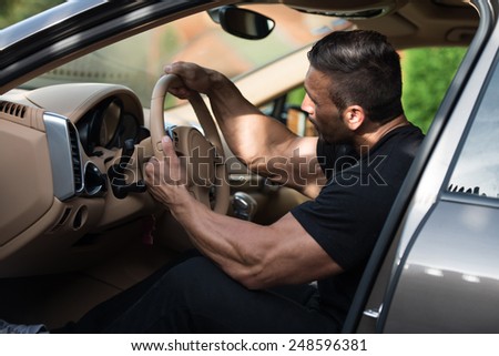 Man In A Track Suit Driving In The Car