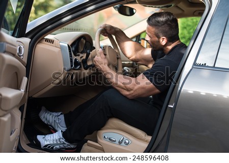 Man In A Track Suit Driving In The Car