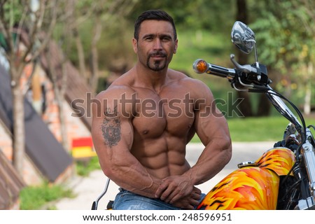 Biker Man Bodybuilder Sits On A Bike